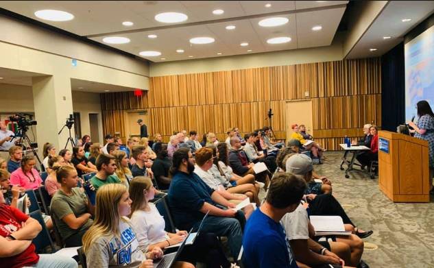 lecture hall full of students at a Dem 101 event